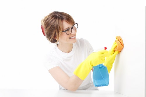 Cleaner disinfecting lift buttons in a shared building area